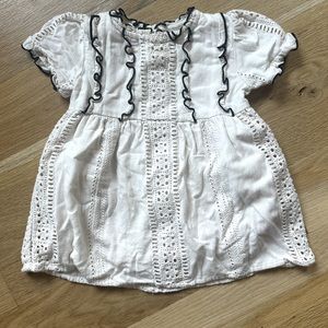 Cream Zara eyelet dress with black ruffle trim details. Size 12-18 months.